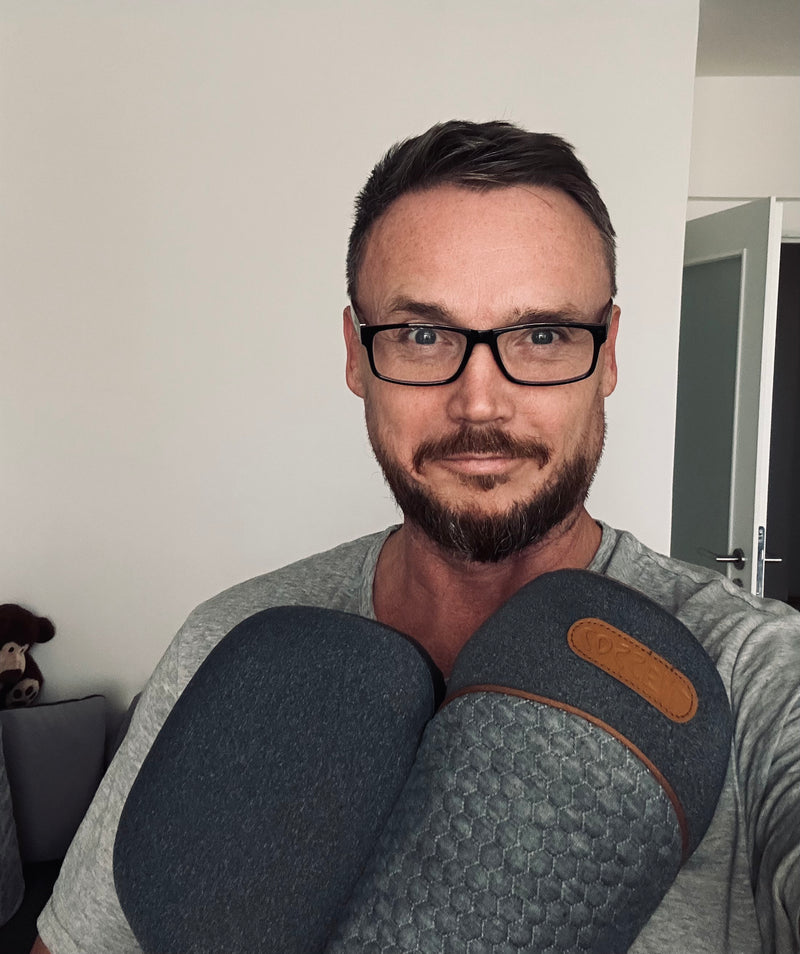 Kenneth holding the pillow at home