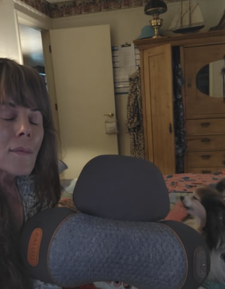 Deborah holding her pillow in the bedroom